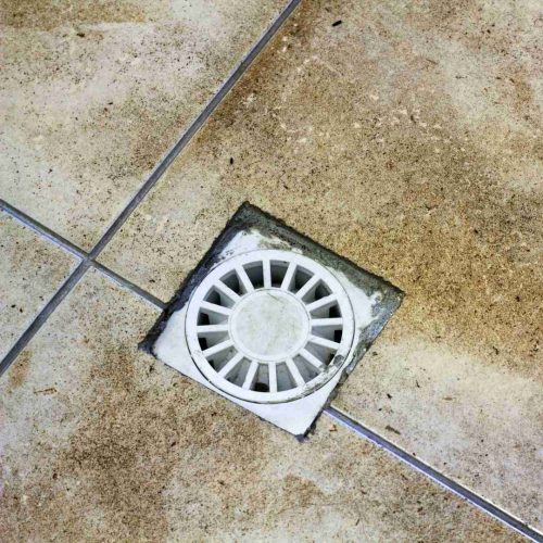 Water drain vent in kitchen, bathroom or basement ceramic tiled old vintage floor